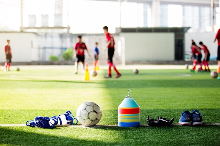 Football equipment next to a football pitch