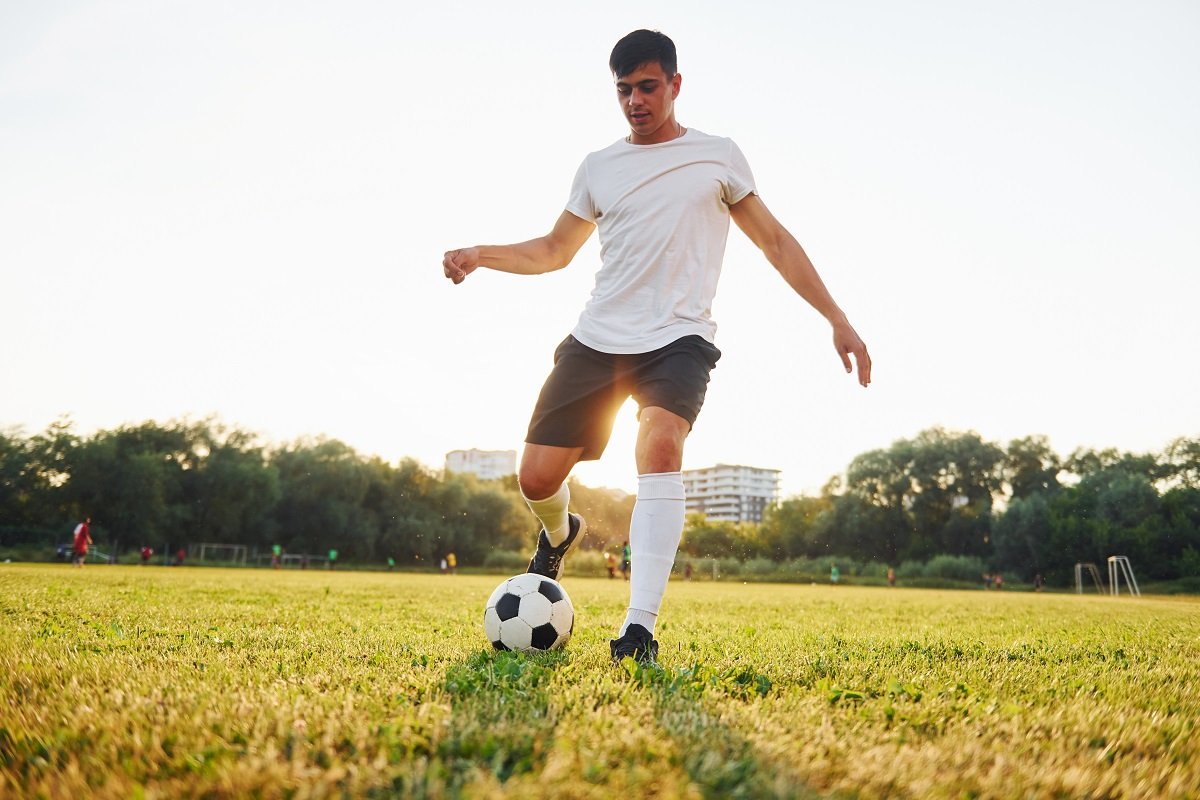 Football player passing the ball in training