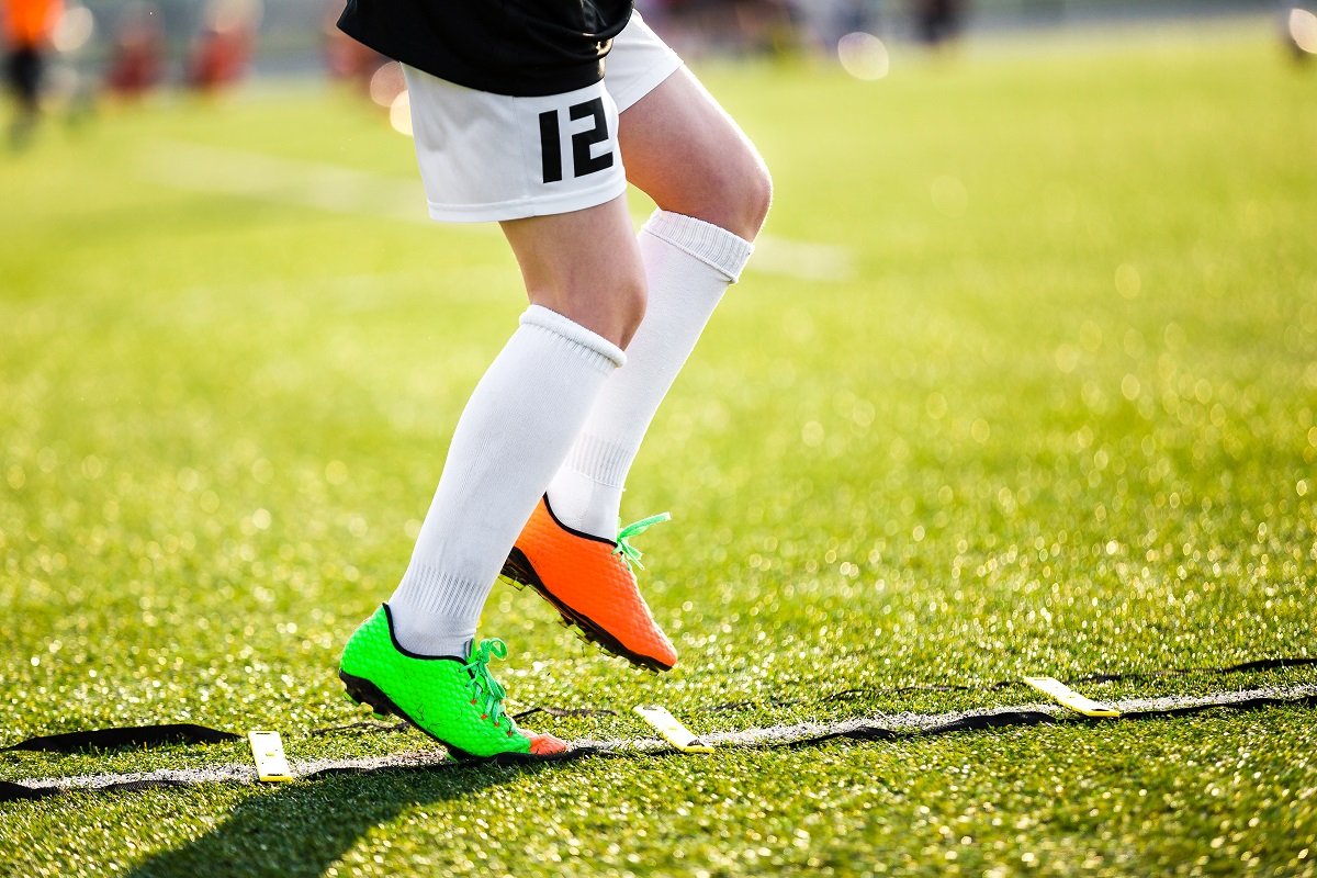 Footballer using an agility ladder