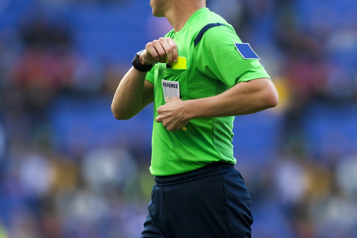 Referee with yellow card
