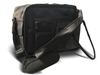 A black coach's bag rests on a surface. It features multiple zippered compartments and a long adjustable strap.