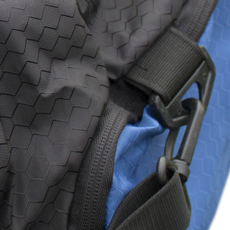 A dark grey bag's textured fabric is shown with a black strap and a clasp attached. The bag's zipper is visible, and it is partially folded to reveal a blue lining.