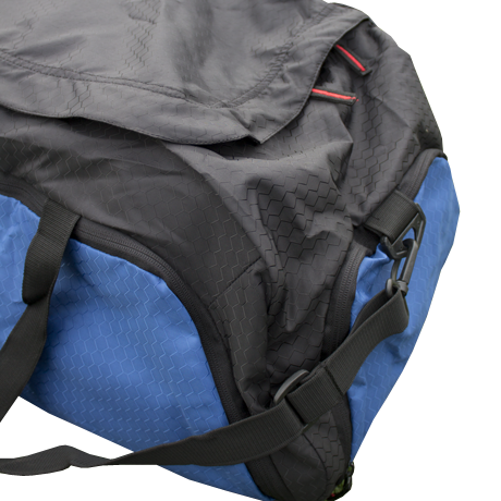 A blue and black duffel bag sits, angled, against a white background.