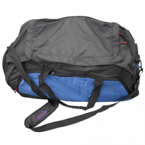 A blue and black duffel bag rests on the grass. The bag is closed. A small logo is visible on the shoulder strap: DIAMOND.
